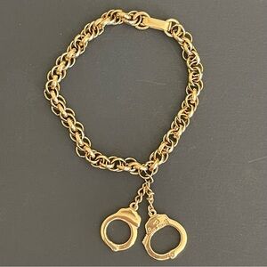 Gold tone Bracelet with Handcuff Charm.